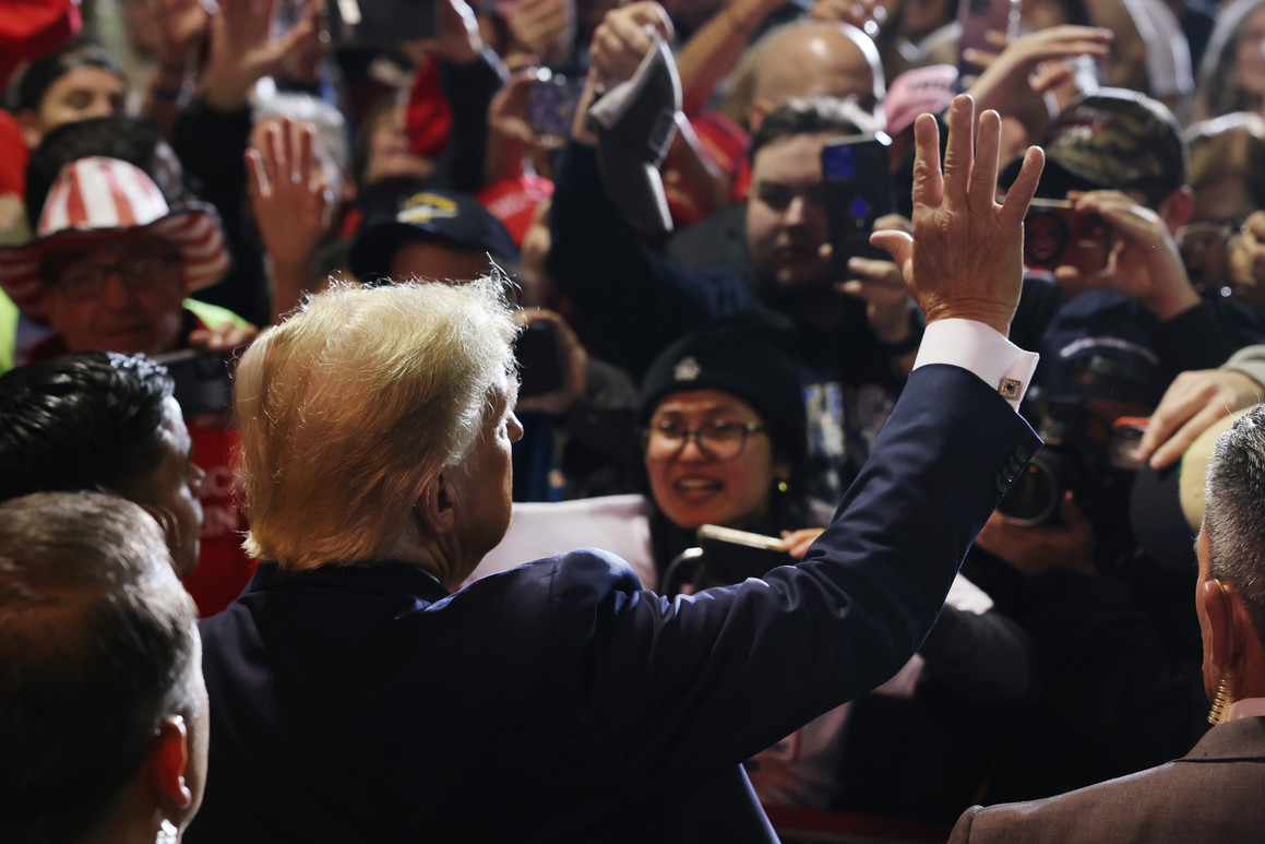 Donald Trump waves to a crowd of supporters. 