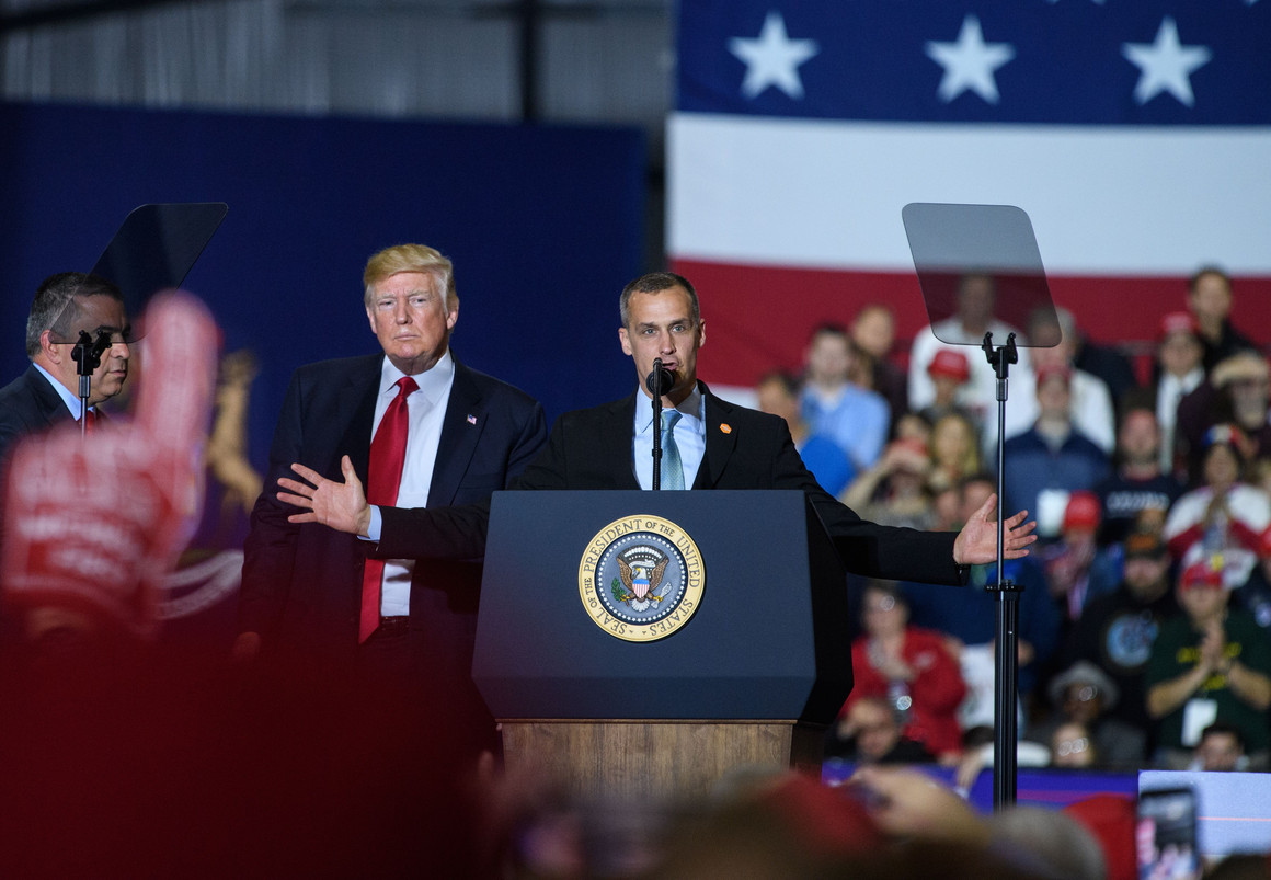 Former Trump campaign manager Corey Lewandowski speaks as then-President Donald Trump looks on during a rally in Washington, Michigan on April 28, 2018.