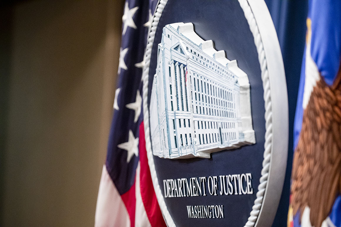 The Department of Justice seal on the stage.