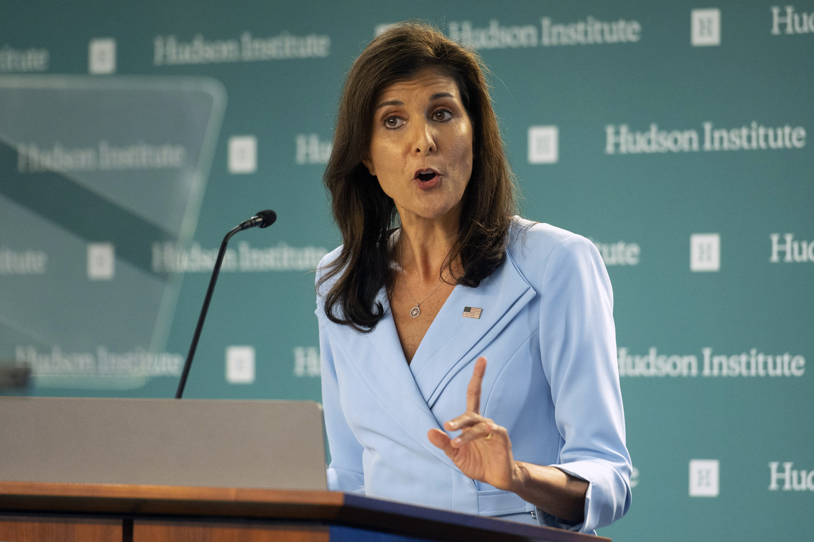Nikki Haley speaking into a microphone holding up an index finger.
