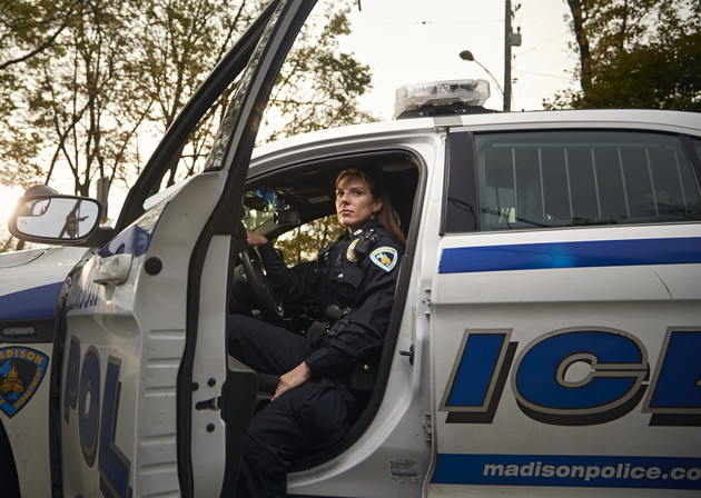 Natalie Deibel, a police officer in Madison, Wis., sits in her cruiser earlier this month. A third of Deibel’s class was female; this year’s class is 37 percent female.