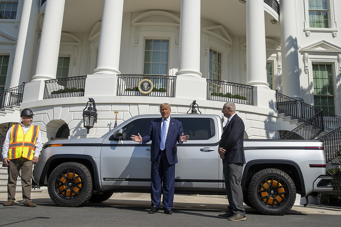 Donald Trump chats with Steve Burns in front of an all-electric pickup truck on the south lawn of the White House. 