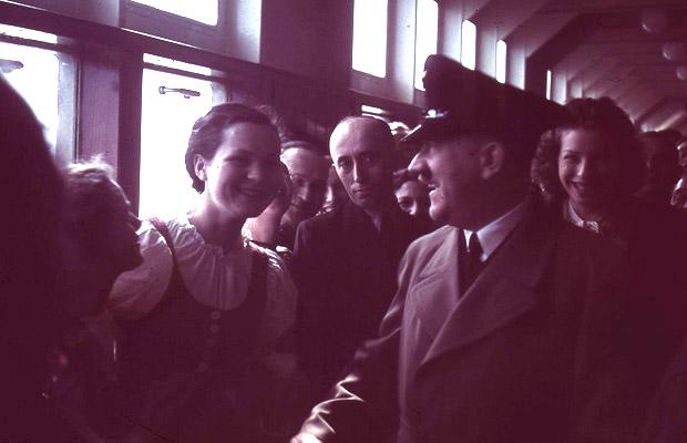 Adolf Hitler chats with several young women on a promenade of the German cruise ship Robert Ley (named after a prominant Nazi labor leader) on its maiden voyage on April 1st, 1939