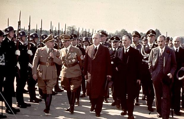 British Prime Minister Neville Chamberlain (front row, second right) walks past a Nazi honor guard on the way to a meeting with Adolf Hitler on September 28, 1938