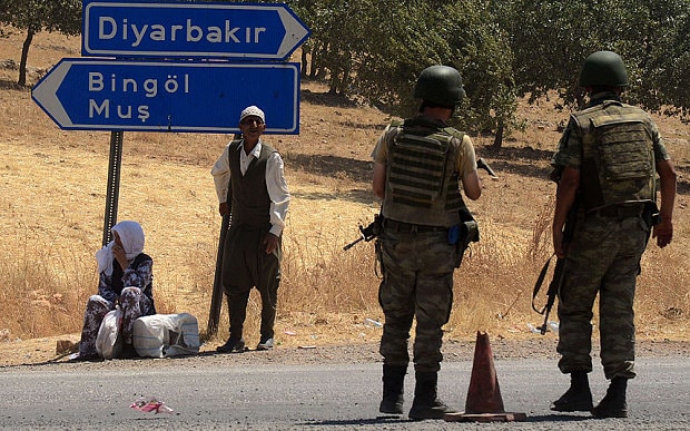 Turkish solders wait at a check point in Diyarbakir on July 26, 2015 following the death of two Turkish soldiers.