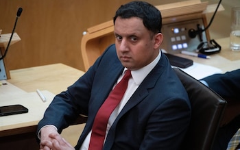 Anas Sarwar sitting in the Scottish Parliament, wearing an appropriately red tie