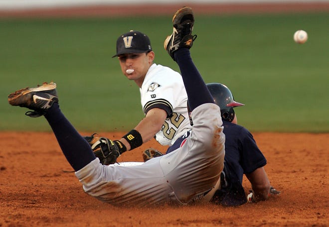 2008: Ryan Flaherty - Belmont's Brandon McCall (5) dives safely into second as Vanderbilt's Ryan Flaherty (22) can't control a wild throw.
