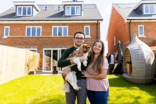 Tom and Cami Ghosh with their dog, Dexter, at their new home near Guildford, Surrey