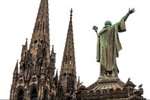 Statue of Pope Urban II overlooking the towers of the Gothic Cathedral of Our Lady of the Assumption in France