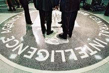 People standing of CIA logo in CIA building