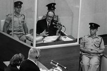 Adolf Eichmann in a glass booth during his trial