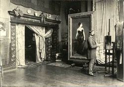John Singer Sargent in his Paris studio, with the painting, Madame X. Sargent faces the painting The Breakfast Table, 1884, in progress.