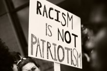 Black and white photo of an anti-racism sign.