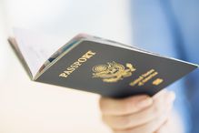 USA, New Jersey, Jersey City, Close up of woman's hand holding open passport