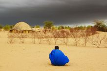 Storm clouds over traditional house in Mali