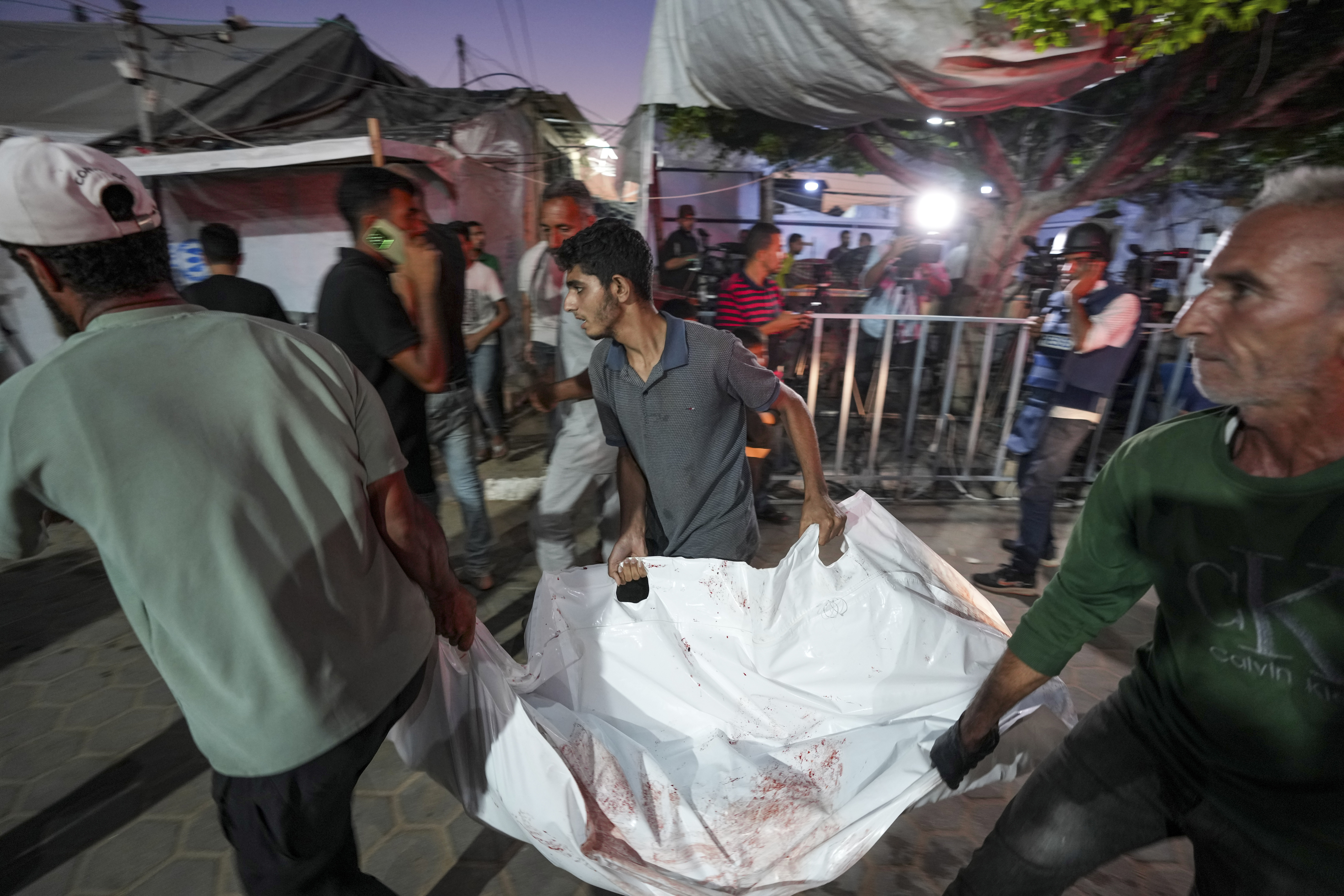 Palestinians bring people killed in the Israeli bombardment of the Gaza Strip into a hospital in Deir al Ballah on Wednesday, June 5, 2024. (AP Photo/Abdel Kareem Hana)