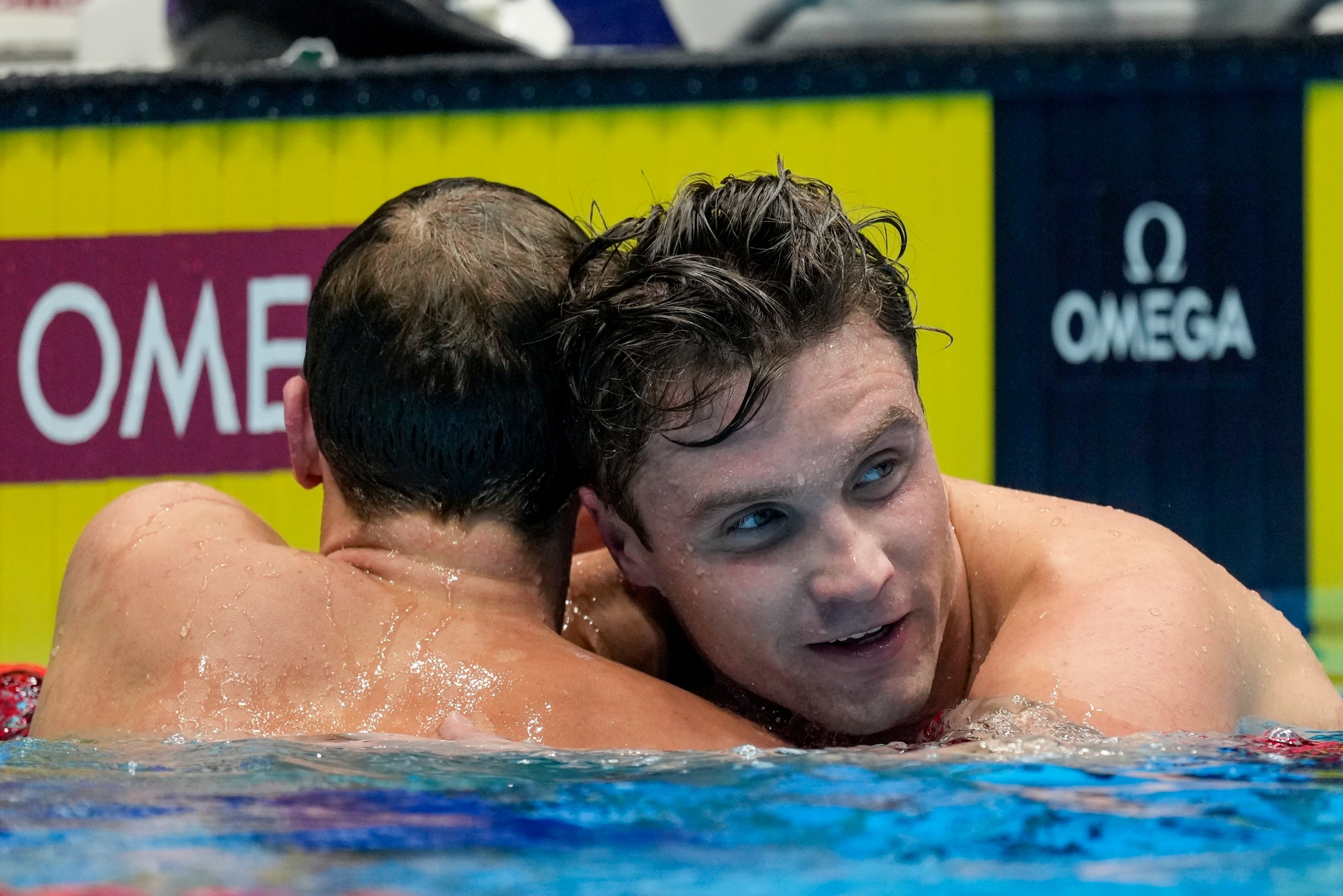 Robert Finke and David Johnston react after the Men's 1500 freestyle finals Sunday, June 23, 2024, at the US Swimming Olympic Trials in Indianapolis. (AP Photo/Michael Conroy)