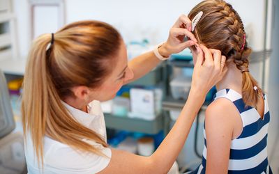 Doctor examining young girl's ear
