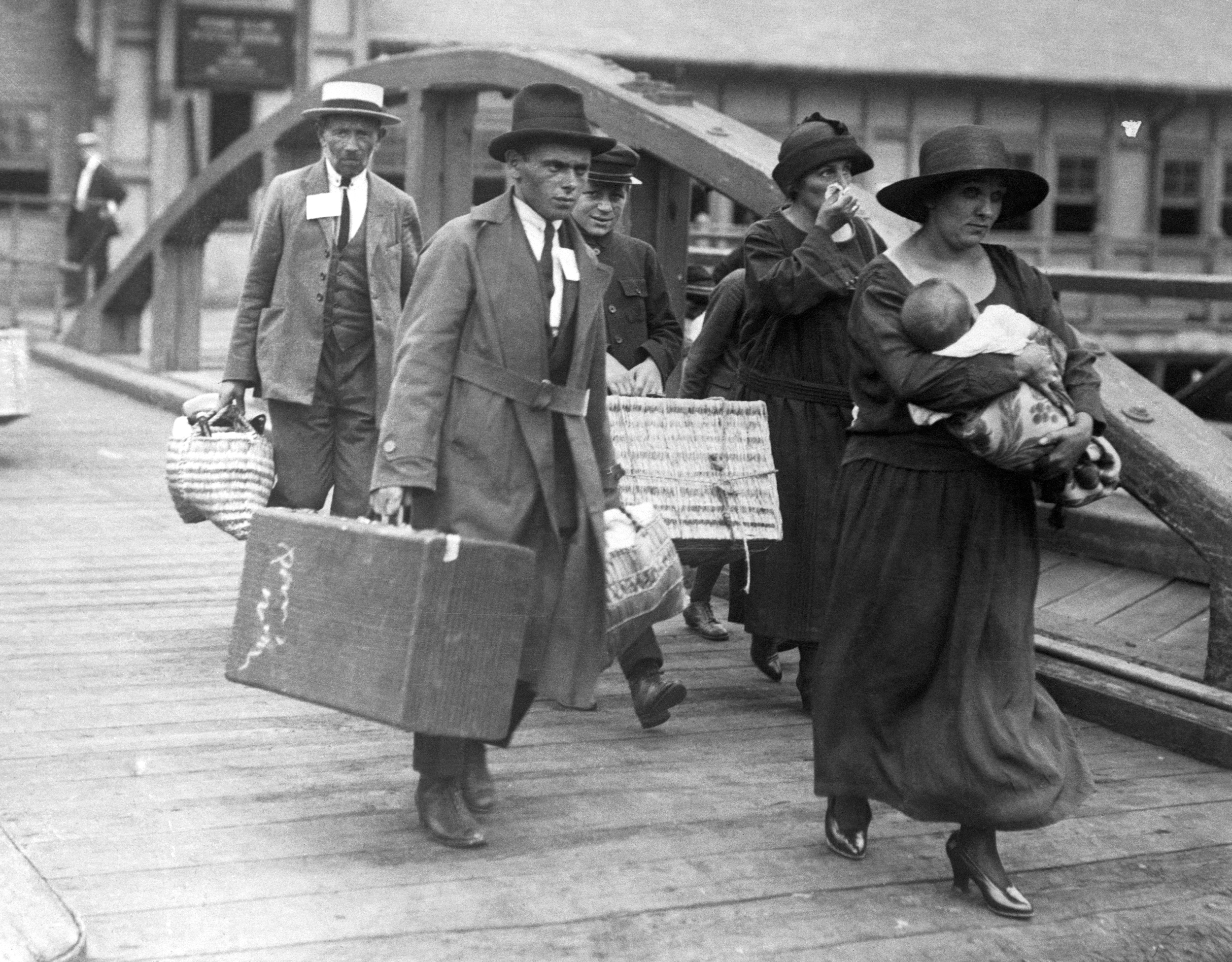 Ship loaded with immigrants, coming to New York. A Greek family embarking on Ellis Island, to come to America.