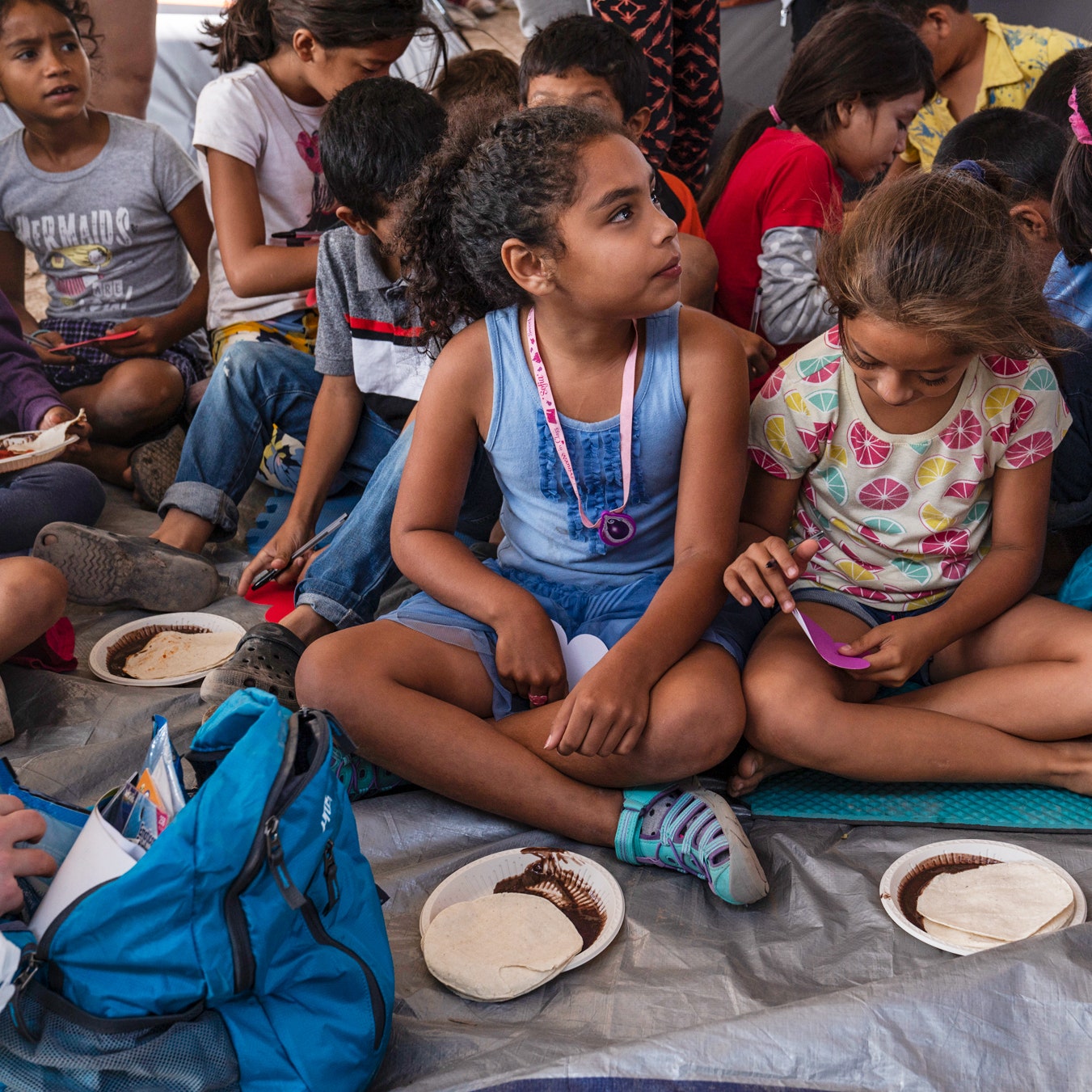 Asylumseeking children eat a meal while they are in their onceaweek class in an encampment where they live in Matamoros...