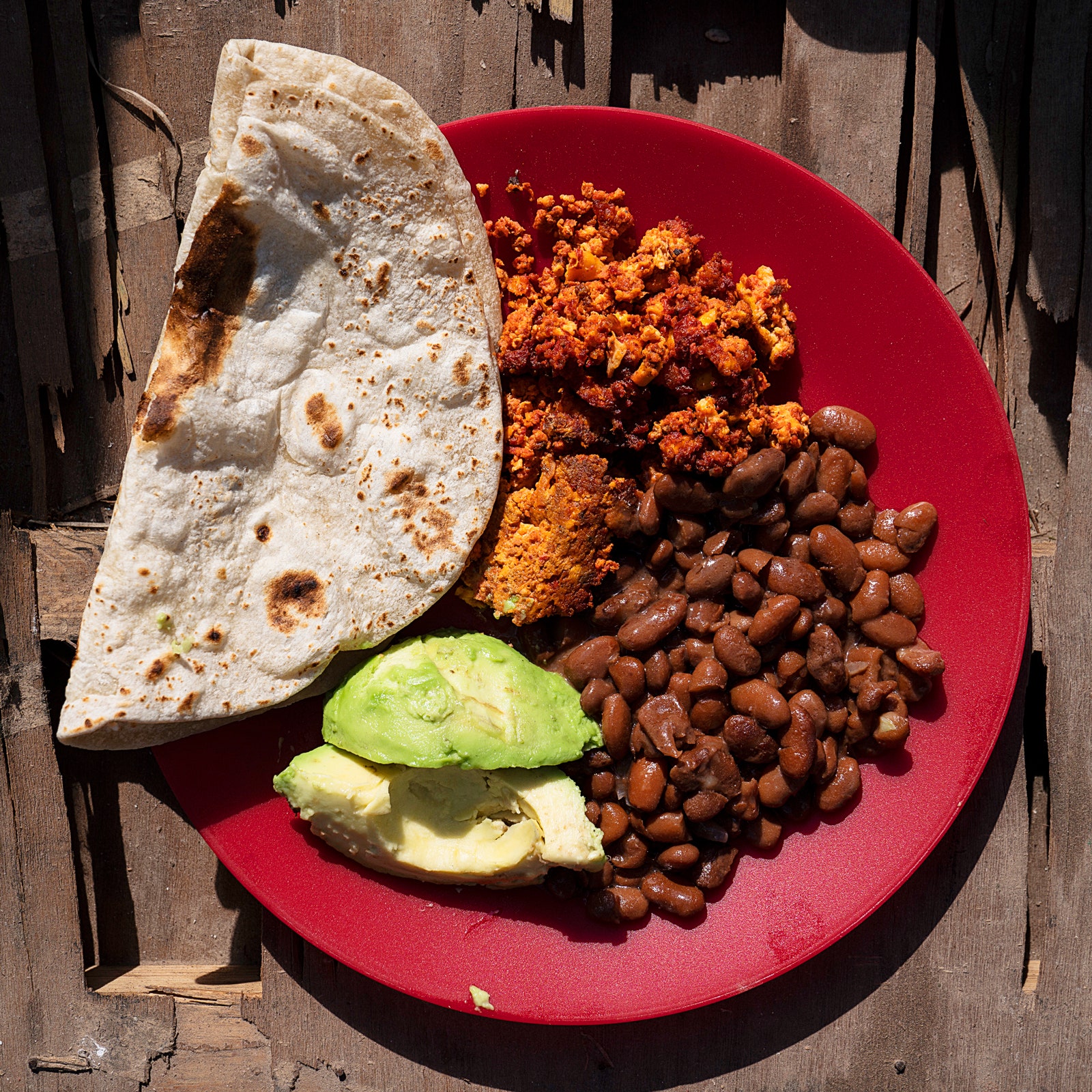 Honduran asylum seeker Jennys cooked meal is seen in an encampment where she lives with approximately 2000 other people...