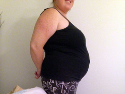 woman 14 weeks pregnant showing her belly