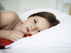 young girl with diarrhoea lying in bed