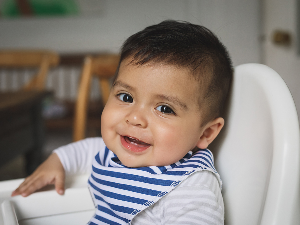 baby boy in high chair, smiling