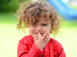 Young child biting their nails