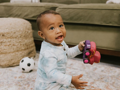 Baby playing with toy truck