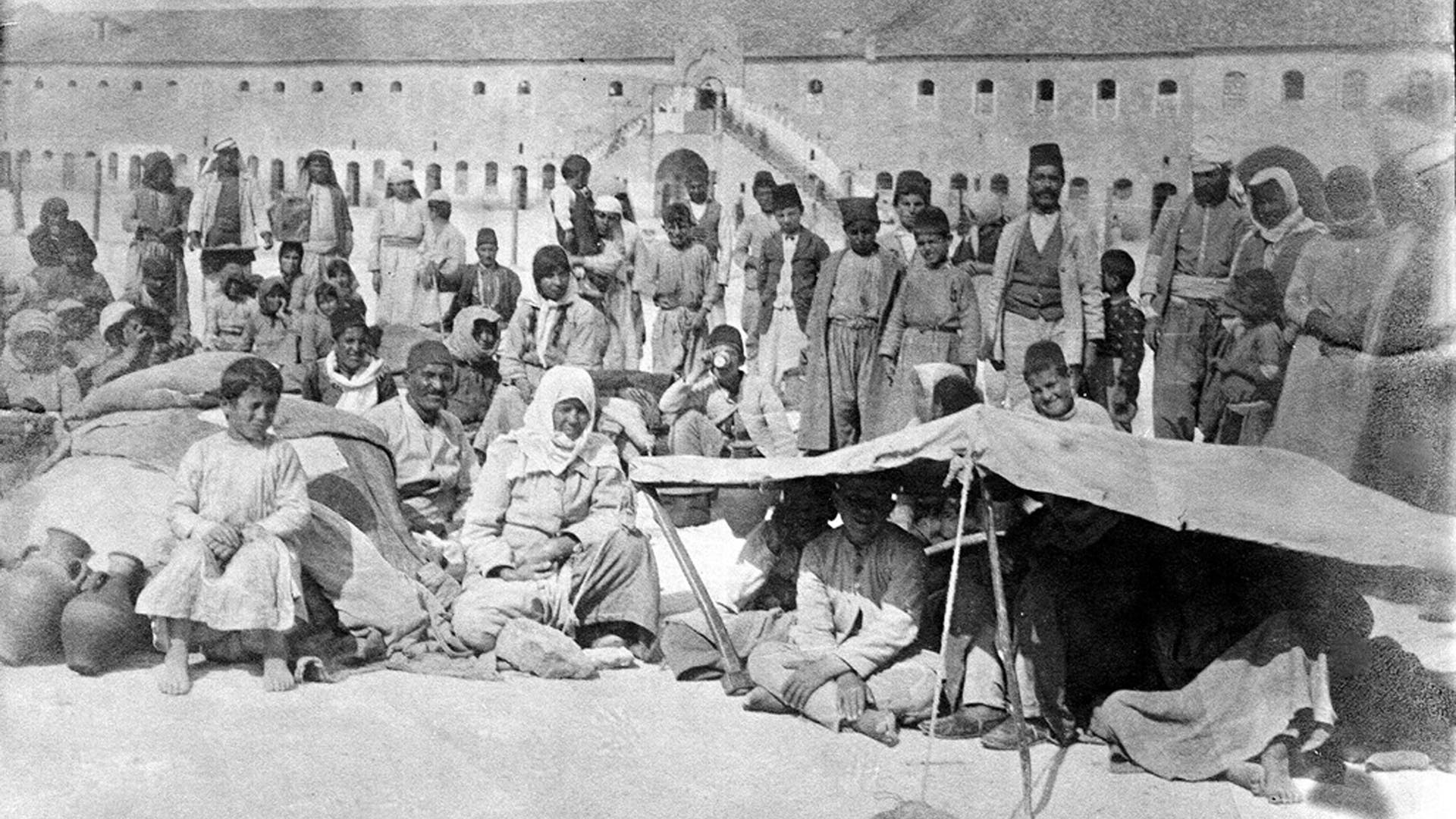 Armenian Genocide, survivors gathered in the barracks at Aleppo, c1918.The Armenian Genocide refers to the deliberate and systematic destruction of the Armenian population of the Ottoman Empire during and just after World War I. It was implemented through wholesale massacres and deportations, with the deportations consisting of forced marches under conditions designed to lead to the death of the deportees. The total number of resulting Armenian deaths is generally held to have been between one and one and a half million. Other ethnic groups were similarly attacked by the Ottoman Empire during this period, including Assyrians and Greeks, and some scholars consider those events to be part of the same policy of extermination. It is widely acknowledged to have been one of the first modern genocides, as scholars point to the systematic, organized manner in which the killings were carried out to eliminate the Armenians, and it is the second most-studied case of genocide after the Holocaust. The word genocide was coined in order to describe these events. (Photo by: Pictures From History/Universal Images Group via Getty Images)
