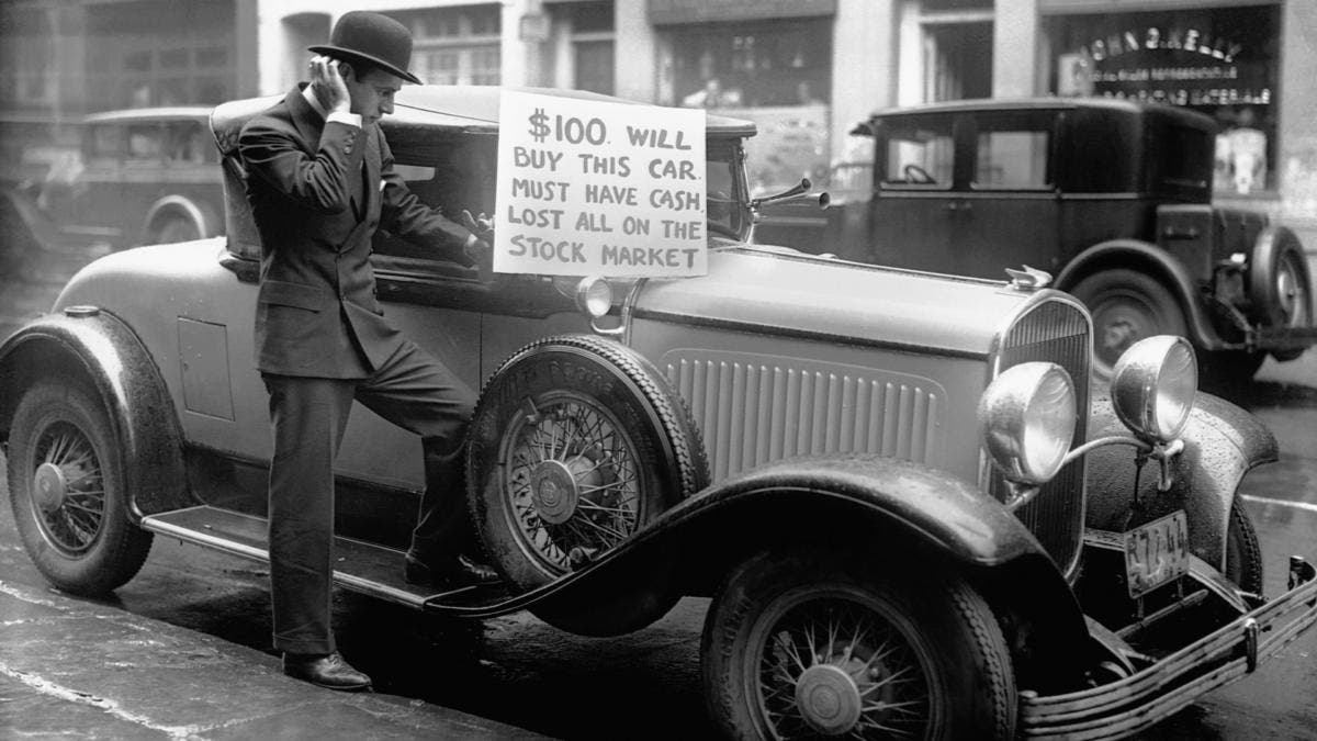 Bankrupt investor Walter Thornton trying to sell his luxury roadster for $100 cash on the streets of New York City following the 1929 stock market crash. (Credit: Bettmann Archive/Getty Images)