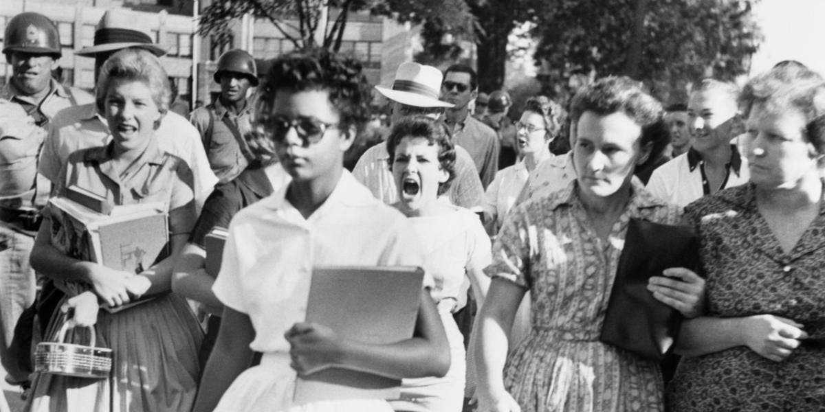 Elizabeth Eckford ignores the hostile screams and stares of fellow students on her first day of school. She was one of the nine negro students whose integration into Little Rock's Central High School was ordered by a Federal Court following legal action by NAACP. (Credit: Bettmann Archive/Getty Images)