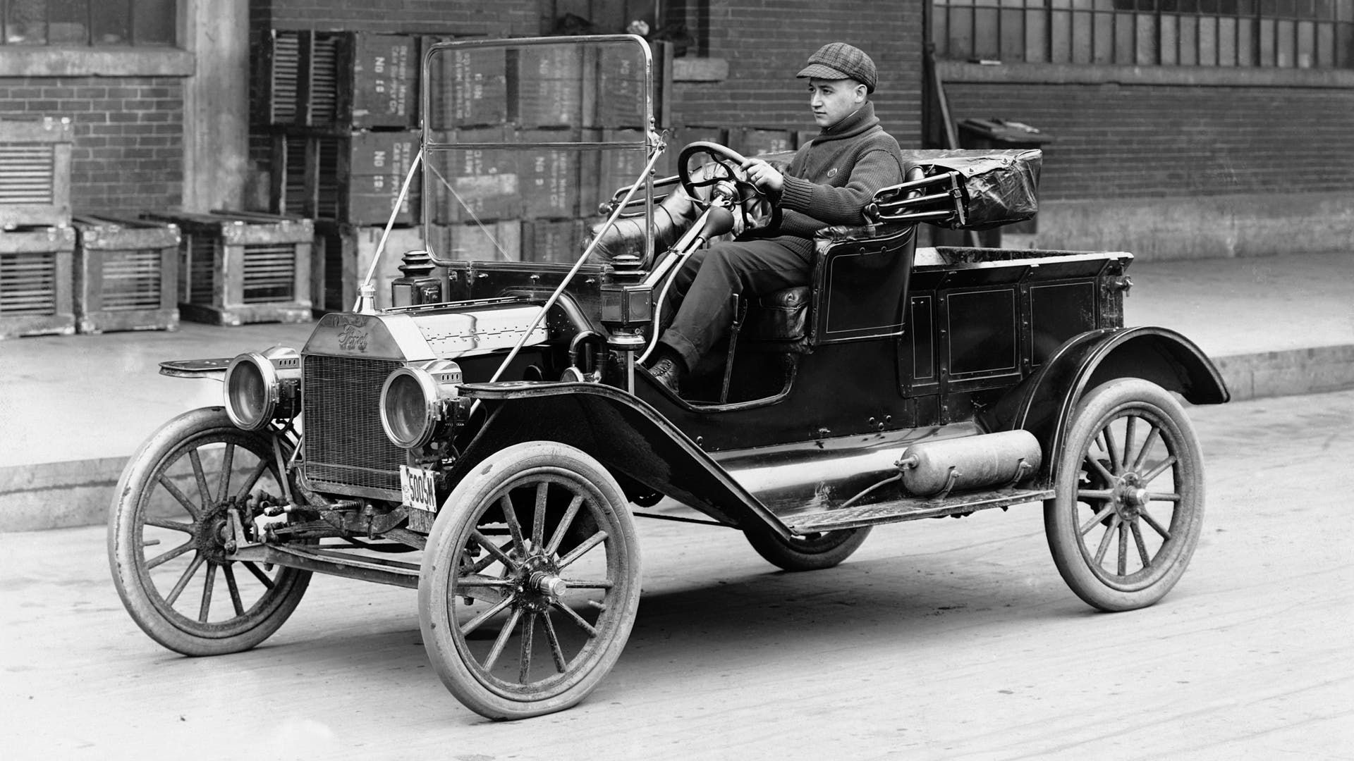 Man Driving Ford Model T A man drives a Ford Model T automobile in the 1920's. (Photo by © Hulton-Deutsch Collection/CORBIS/Corbis via Getty Images)