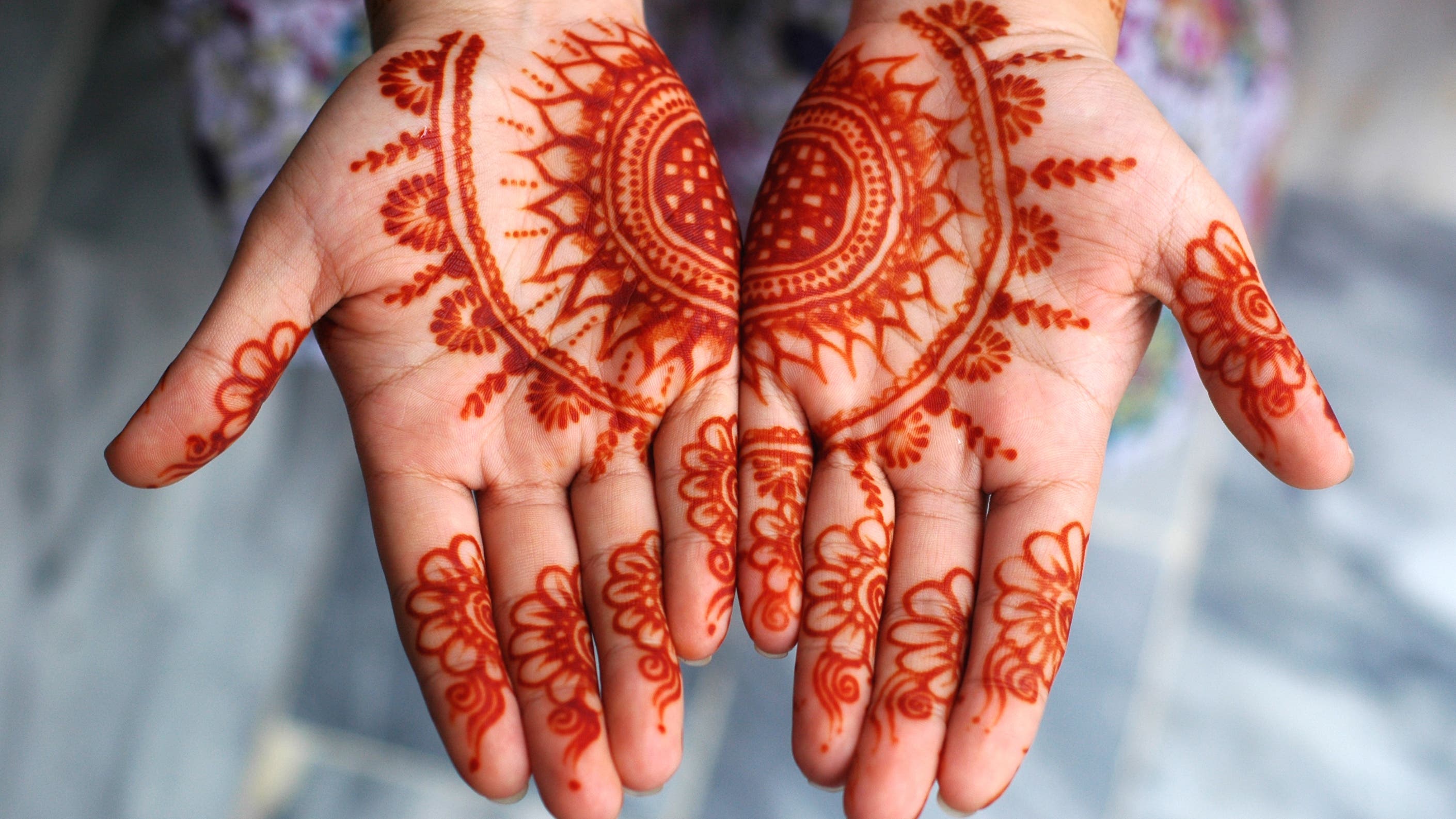 A woman displaying her mehndi (henna) on occasion of Eid-al-Fitr, celebrated at the end of the holy month of Ramadan.
