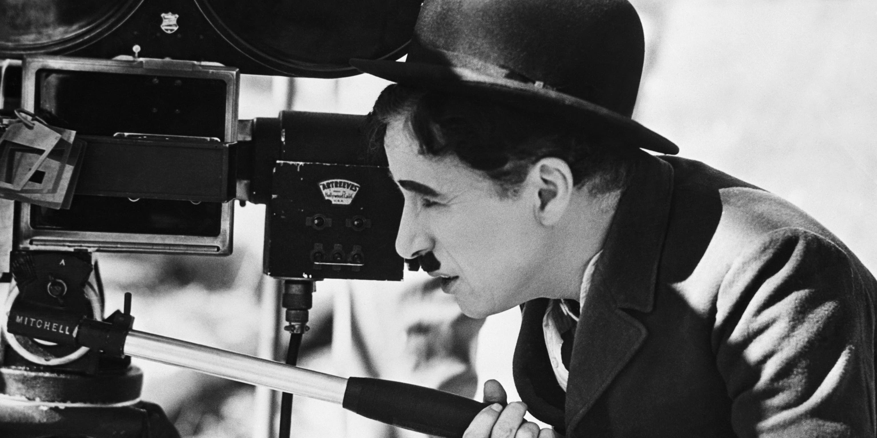 Actor Charlie Chaplin looks though a movie camera on April 22, 1935. He is directing, as well as acting in, a comedy tentatively titled Production No. 5.