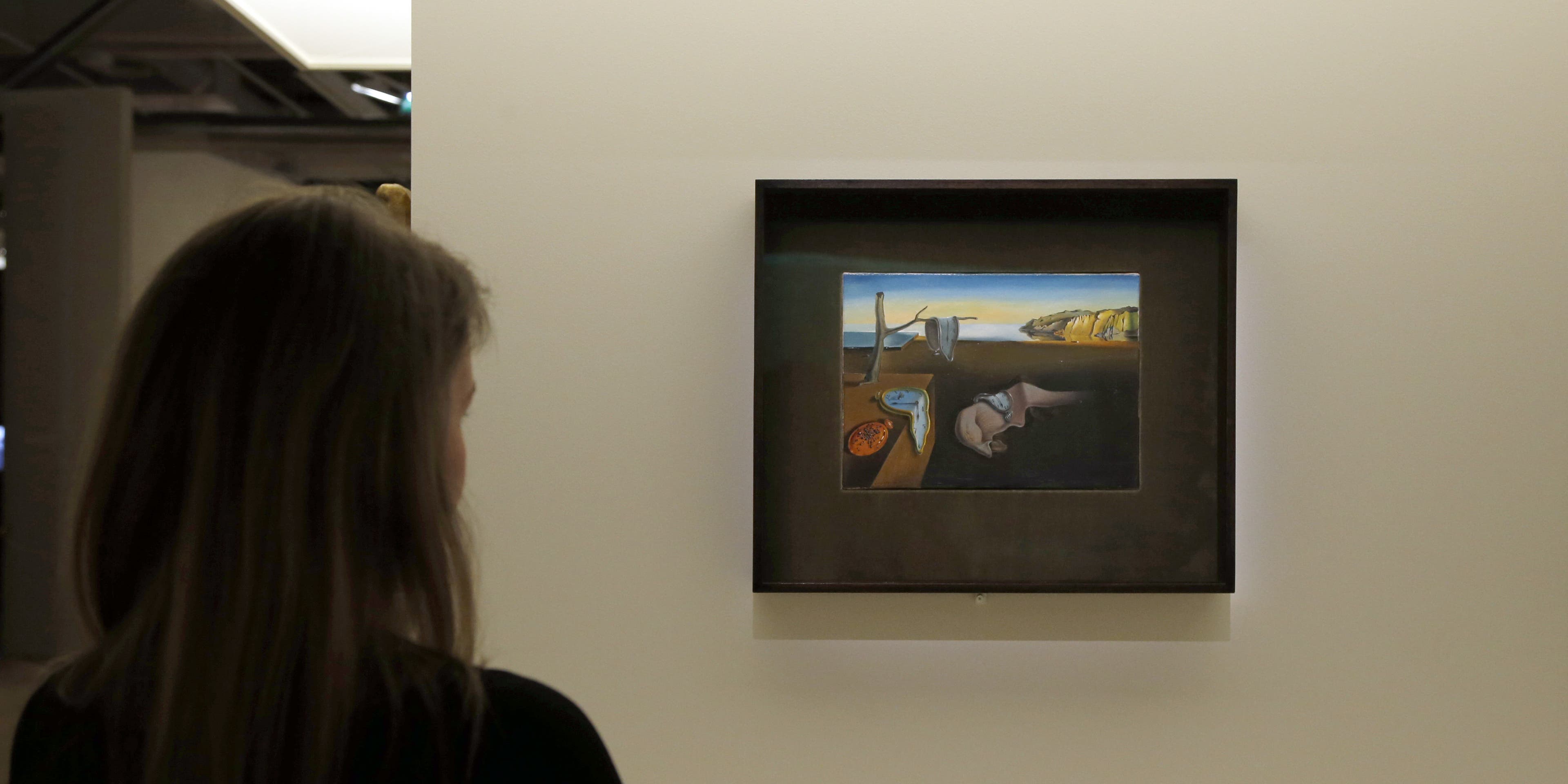 A visitor looks at a painting entitled "La persistance de la mémoire" (Persistence of Memory) by Spanish surrealist artist Salvador Dali's during an exhibition devoted to his work at the Centre Pompidou contopary art center (aka Beaubourg) on November 19, 2012 in Paris. More than 30 years after the first retrospective in 1979, the event gathers more than 200 art pieces and runs until March 13, 2013. AFP PHOTO FRANCOIS GUILLOT (Photo credit should read FRANCOIS GUILLOT/AFP via Getty Images)