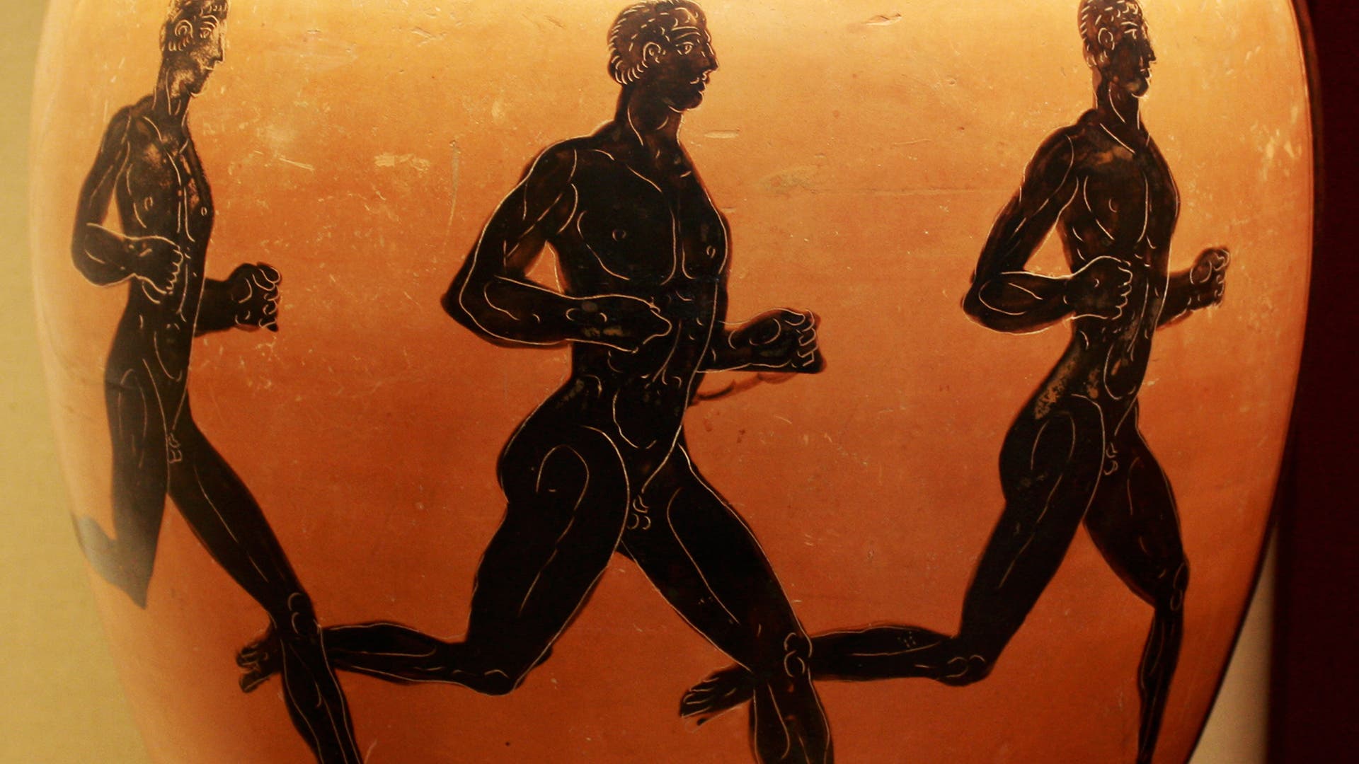 Ancient Greek Sports. Three nude athletes are depicted competing in a foot-race on an ancient Greek amphora. (Photo by: Universal History Archive/Universal Images Group via Getty Images)