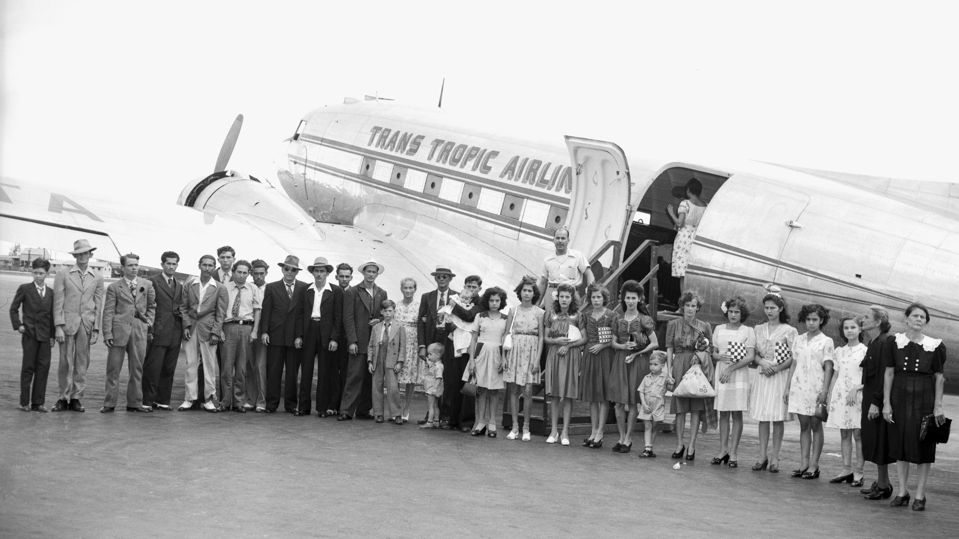 July 18, 1946: Jose Rodriguez bringing 31 family members to Brooklyn, N.Y., where he has been working, to live together in a 10-room apartment he acquired. They're shown here arriving at Miami, Florida, from Isabella, Puerto Rico. The oldest member of the party is Jose's 73-year-old grandmother, Mrs. Francisca Rodriguez Cortes, and the youngest is his four-month-old daughter.