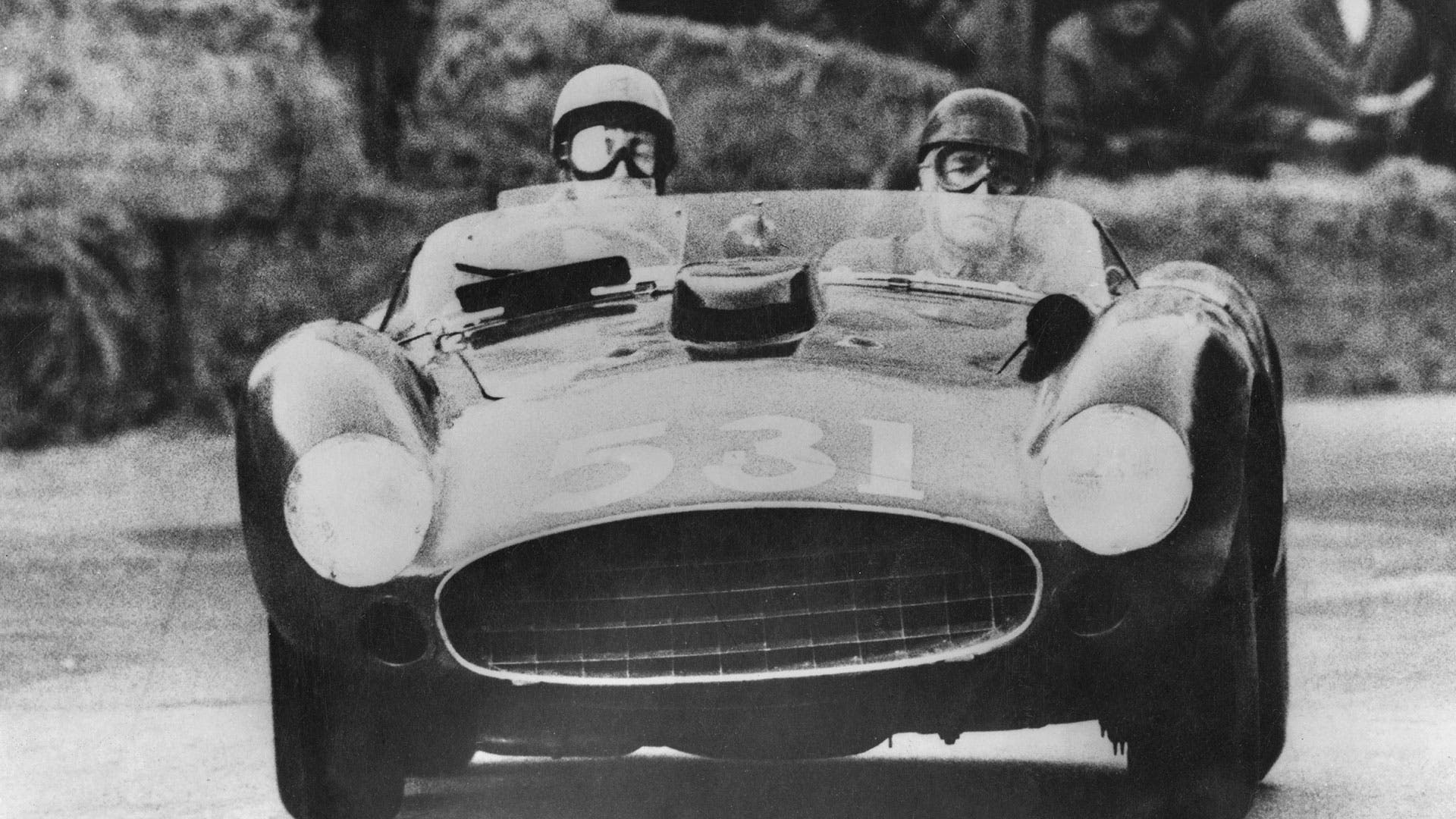 Alfonso de Portago, the Marquis of Portago (1928 - 1957) and his co-driver Edmund Nelson in their Ferrari at Peschiera in Italy during the Italian Mille Miglia road race, 12th May 1957.