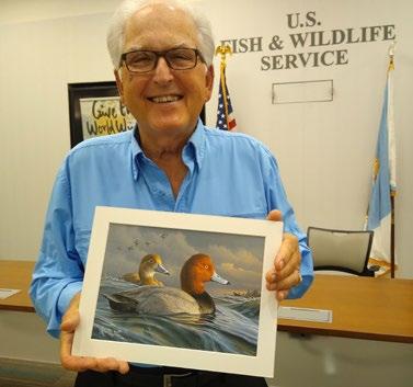 2022 Duck Stamp judge Larry Richardson displays the winning entry by Minnesota artist, James Hautman.