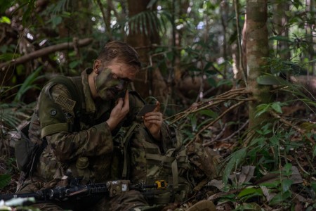 U.S. Army Pfc. Bailey Driskel, a combat engineer assigned to Charlie Company, 1st Battalion, 26th Infantry Regiment, 101st Airborne Division (Air Assault), applies camouflage face paint during the final movement of Exercise Southern Vanguard 24 in Oiapoque, Brazil, on Nov. 15, 2023. Exercise Southern Vanguard 24 is designed for U.S. Army Soldiers to conduct pre-deployment activities, deploy, and conduct air assault operations while enhancing interoperability with Brazilian Army forces. (U.S. Army National Guard photo by Spc. Joseph Liggio)