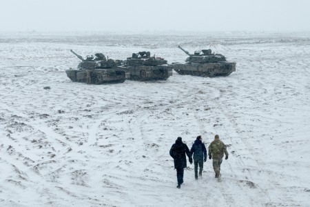 A U.S. Army Soldier with 3rd Battalion, 67th Armored Regiment, 2nd Armored Brigade Combat Team, 3rd Infantry Division, and members of the Lithuanian Parliament take a close-up look at M1A2 Abrams tanks during a tour of Camp Herkus, Lithuania, Jan. 4, 2024.
