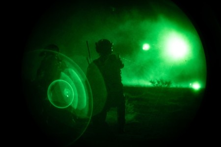 A Soldier assigned to 3rd Special Forces Group (Airborne) marks a landing zone for a CH-47 with an infrared laser after a nighttime raid on a village in support of Sage Eagle 24 on White Sands Missile Range, New Mexico, January 27, 2024. Sage Eagle is a yearly exercise in which Soldiers assigned to 3rd Special Forces Group (Airborne) conduct training in preparation for real world missions.