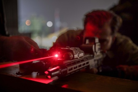 An Army Green Beret adjusts a laser sight to engage targets in low light conditions during Trojan Footprint 2024 near Sofia, Bulgaria, March 1, 2024. Exercise Trojan Footprint provides NATO allies and partner special operations forces an opportunity to enhance their skills, build interoperability and demonstrate their capabilities within the European theater.