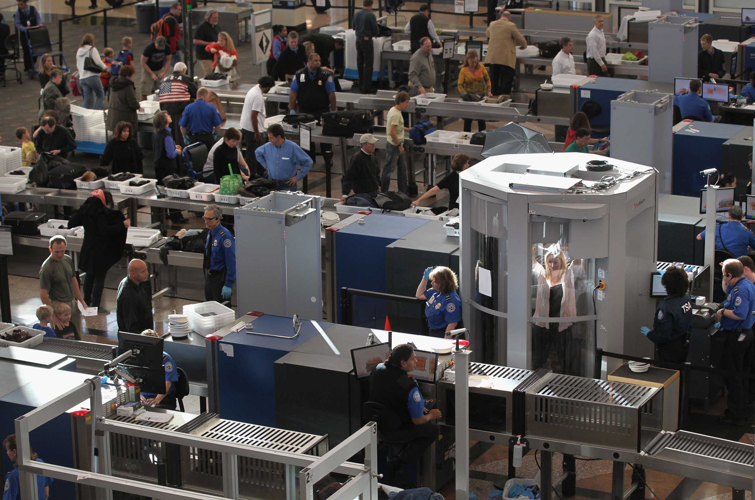 Transportation Security Administration agents screen passengers at Denver International Airport in 2010.