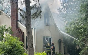 Firefighters put out a house fire in south Minneapolis on the afternoon of May 24. One man who lived at the house died in the blaze.