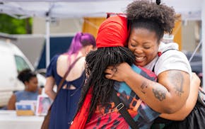 Tamiko French and Atiya Mansfield, left to right, embrace each other during a Juneteenth Festival on Minnehaha Ave. in Minneapolis, MN., on Wednesday,