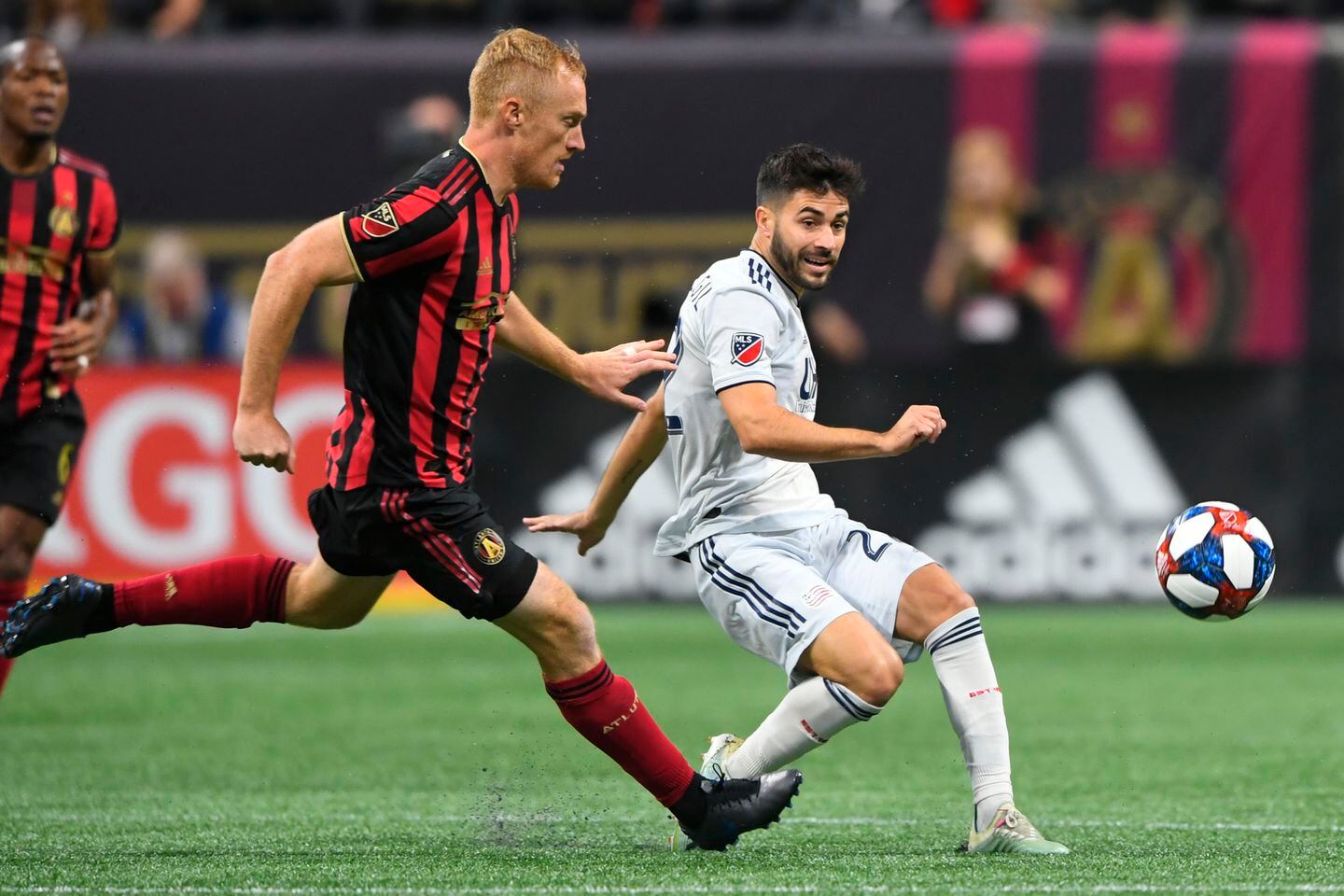Carles Gil (right) and the Revolution couldn’t successfully penetrate the Atlanta United defense.