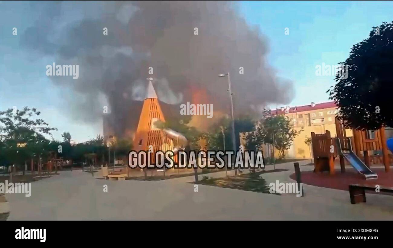 CORRECTS THE CITY TO DERBENT - In this photo made from video released by Golos Dagestana, smoke rises following an attack at a synagogue in Derbent of the Republic of Dagestan, Russia, Sunday, June 23, 2024. Russian state news agency RIA Novosti says that armed militants attacked two Orthodox churches, a synagogue and a traffic police post in Russia's southern republic of Dagestan, killing a priest and six police officers. (Golos Dagestana via AP) Stock Photo